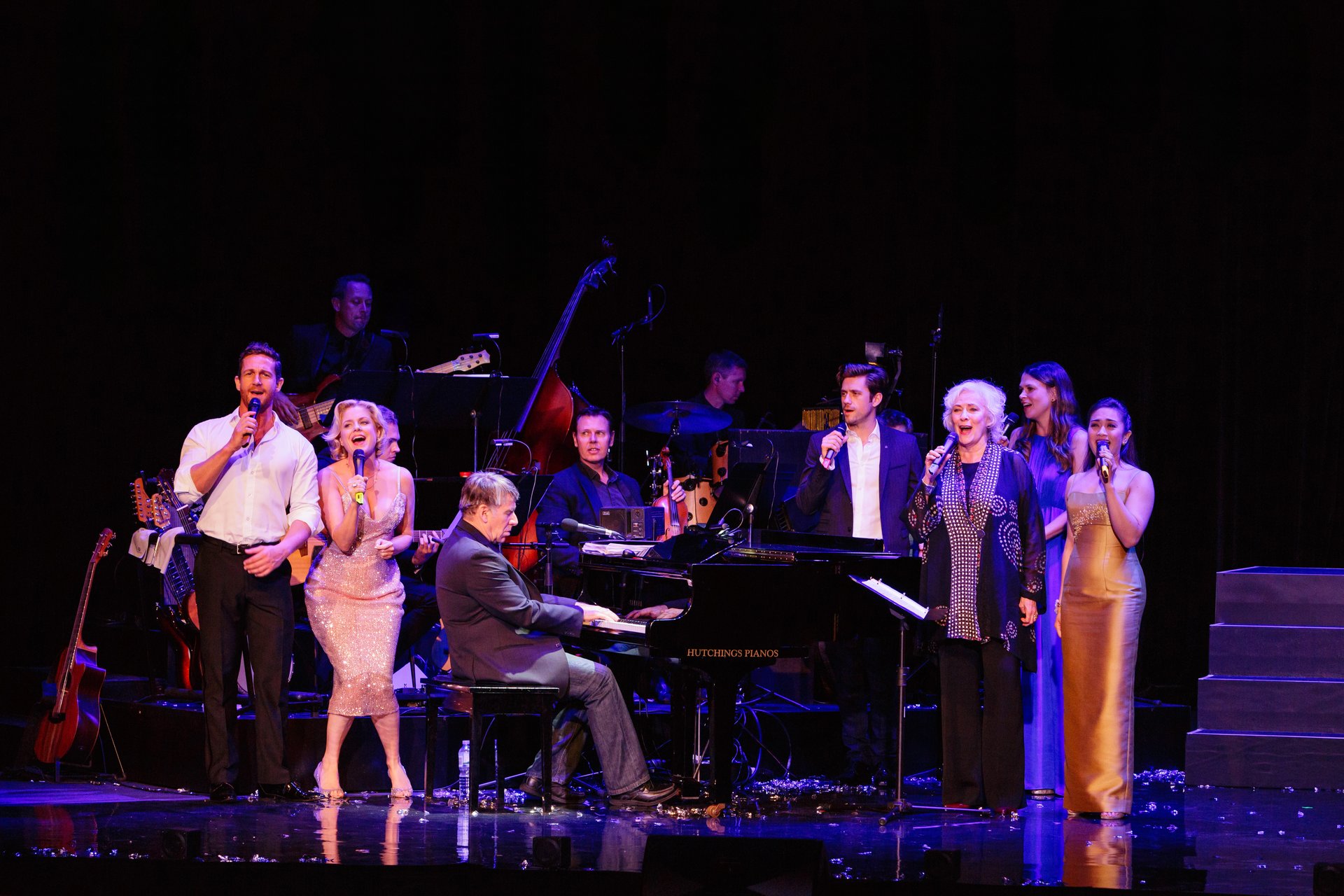 The original Sydney company performing around the piano with Stephen Schwartz.